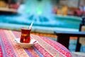 Glass of of traditional Turkish tea on the table with color background Royalty Free Stock Photo