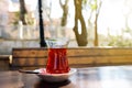 Glass of traditional turkish tea on a wooden table of street cafe on sunny spring day in Istanbul, Turkey Royalty Free Stock Photo