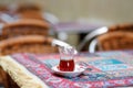 Glass of traditional turkish tea on a wooden table of street cafe on sunny spring day in Istanbul, Turkey Royalty Free Stock Photo