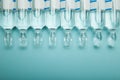 Glass transparent ampoules in a row, empty space for text Royalty Free Stock Photo