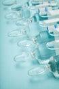 Glass transparent ampoules in a row, empty space for text. Royalty Free Stock Photo