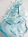 Glass transparent bottle on a white gray background broken into many fragments. Blue is a lot of fragments from under gaziorovki. Royalty Free Stock Photo