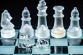 glass, transparent chess pieces on a checkerboard, selective focus, close-up, isolated on black Royalty Free Stock Photo