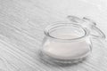 Glass transparent container with sugar on a white old wooden table Royalty Free Stock Photo