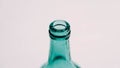 Glass transparent green bottle for liquids without the cap on a white background Royalty Free Stock Photo