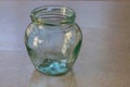 Glass transparent jar standing on a countertop with an empty copy space on the right side and with a blurred background. Blank for Royalty Free Stock Photo