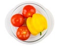 Glass transparent plate with tomatoes and sweet pepper on white Royalty Free Stock Photo