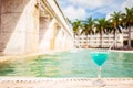 Glass of tropical cocktail on a background of swimming pool Royalty Free Stock Photo