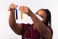 Glass tubes with fluids in nurse hand during medical test. Vaccine development, experiments and science concept. Royalty Free Stock Photo