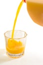 A glass tumbler is being filled with fresh squeezed Florida orange juice Royalty Free Stock Photo