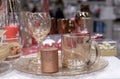 Glass tumbler, wine glass and shiny candle on the festive New Year`s table Royalty Free Stock Photo