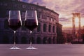 Glass of two red wine with view of sunset over Rome Colosseum in Rome, Italy Royalty Free Stock Photo