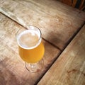 Glass of unfiltered beer on a bar table