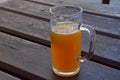 Glass of unfiltered weizen beer on wooden table