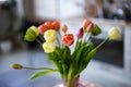 Glass vase with bouquet of beautiful tulips on brick wall background Royalty Free Stock Photo