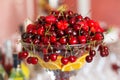 Glass vase with fresh Red cherries, strawberry and orange.