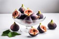 Glass vase with fresh ripe figs and halves on a white table. Ripe summer fruits Royalty Free Stock Photo