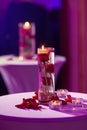 Glass vase with red roses water and light candles Royalty Free Stock Photo