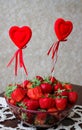 Glass vase with ripe strawberries and Valentines