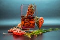 Glass vase with stones grass and harts