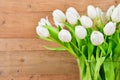 Glass vase with white tulips