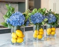 Glass vases hold vibrant blue hydrangeas and fresh lemons, citrus freshness creating fresh, bright, and creative kitchen Royalty Free Stock Photo