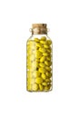 Glass vial full of small yellow pills Royalty Free Stock Photo