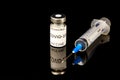 Glass vial Vaccine label Covid - 19 Coronavirus Vaccine text and medical syringe isolated on black Royalty Free Stock Photo