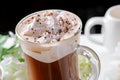 Glass of Viennese coffee close-up on half white black background