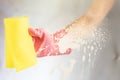 through the glass view of hand in pink glove cleaning window with sponge and spray cleaning f Royalty Free Stock Photo