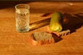 a glass of vodka with pieces of black bread and pickled cucumber. wooden background. drunkenness concept. Royalty Free Stock Photo