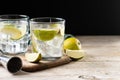 Glass of vodka tonic cocktail on wooden table