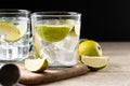 Glass of vodka tonic cocktail on wooden table