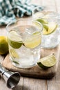 Glass of vodka tonic cocktail on wooden table