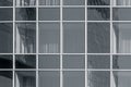 Glass wall with another building reflection. Windows are closed with curtains. Toned for black and white Royalty Free Stock Photo