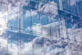 Glass wall of modern office building with cloudy sky reflection Royalty Free Stock Photo