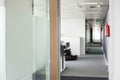 Glass wall and narrow passageway in office Royalty Free Stock Photo