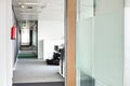 Glass wall and narrow passageway in office Royalty Free Stock Photo