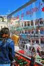 A glass wall with photographs of war veterans.