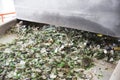 Glass waste in recycling facility. Glass particles in a machine Royalty Free Stock Photo