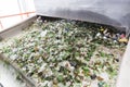 Glass waste in recycling facility. Glass particles in a machine Royalty Free Stock Photo