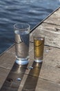 A glass of water and a glass of alcohol on the bridge.