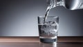 A glass of water being poured from a bottle