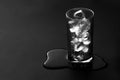 Glass of water on black matte surface Royalty Free Stock Photo