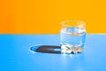 Glass of water on blue background with hard light and shadows, Reflections on water. Alcohol drinks. Thirsty Royalty Free Stock Photo