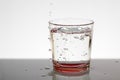 A glass of water with bubbles and splashes Royalty Free Stock Photo