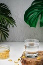 Glass with water and capsules of fish oil with omega-3 and vitamin D next to a glass of water, health care concept. Close-up. Fish Royalty Free Stock Photo