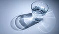 Glass of Water Casting a Shadow with Light Refraction Royalty Free Stock Photo