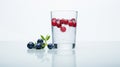 glass of water with cherries and blueberries on a white background Royalty Free Stock Photo