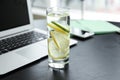 Glass of water with citrus fruits on dark table Royalty Free Stock Photo